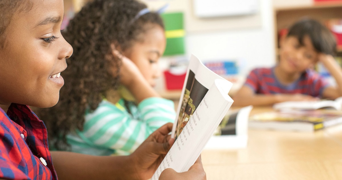 little boy reading book