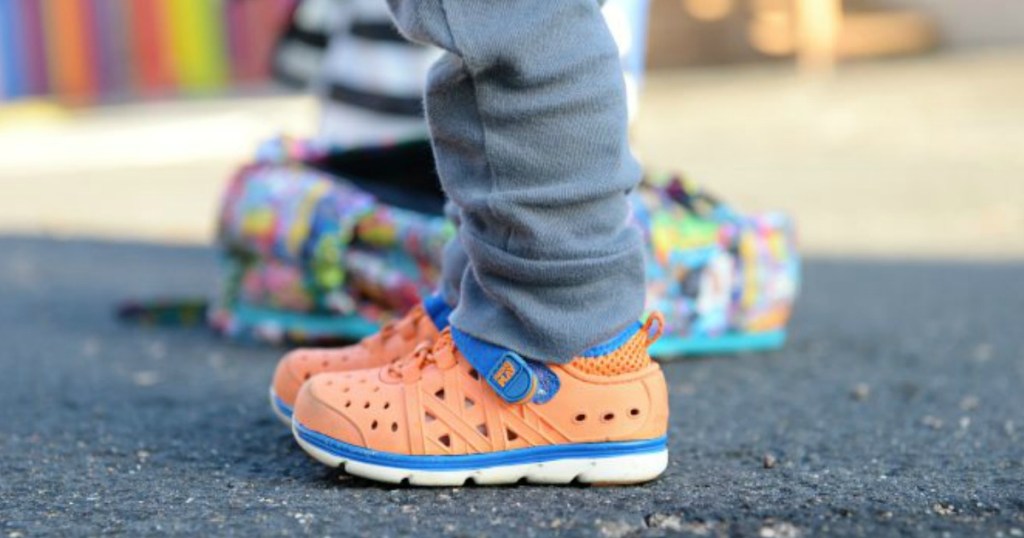 kid wearing Stride Rite Orange Made2Play Phibian Sneaker Sandals