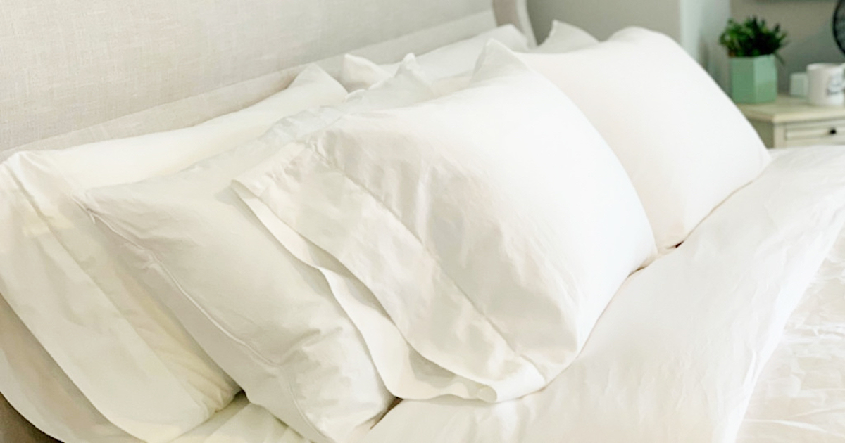 white bedding with pillows 