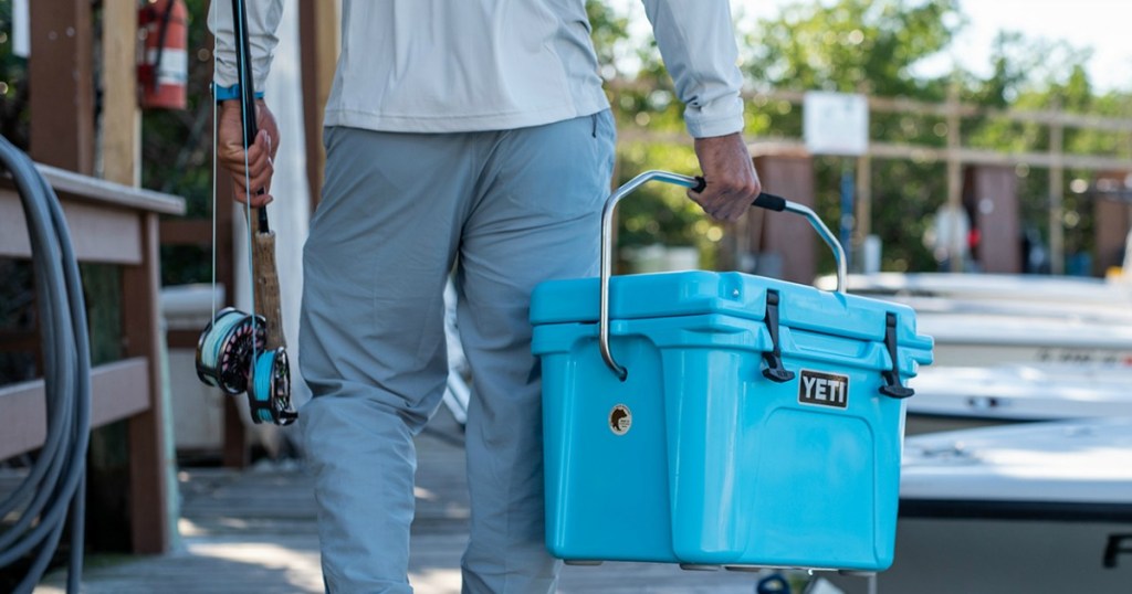 Yeti Roadie Cooler Being carried by man with fishing pole on pier