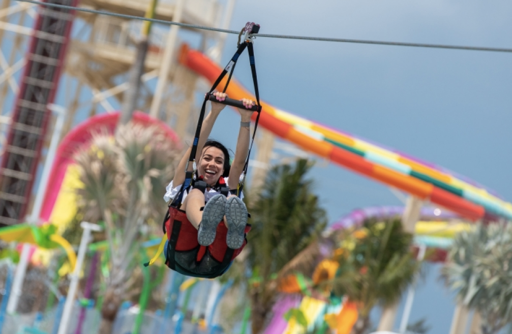 a woman riding a zip line at CocoCay