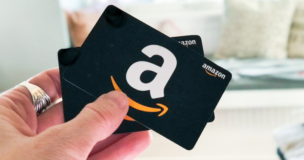 holding up 2 amazon gift cards