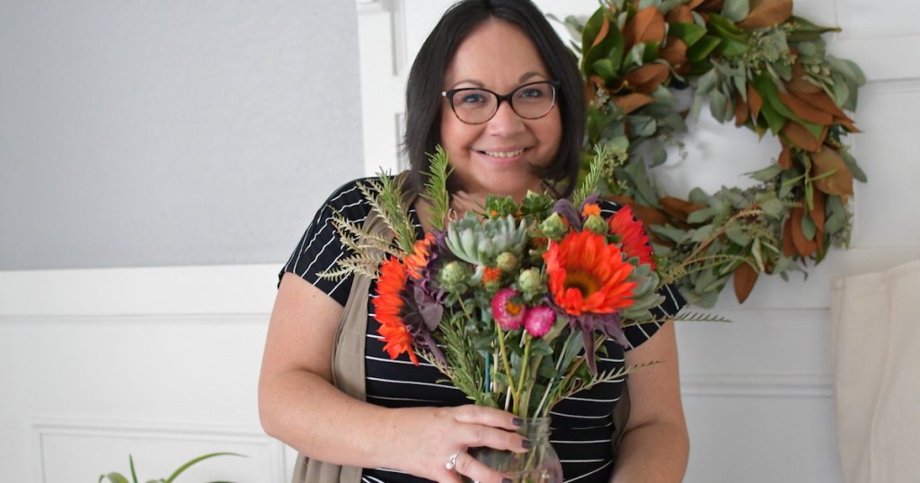 woman holding colorful bouquet of flowers