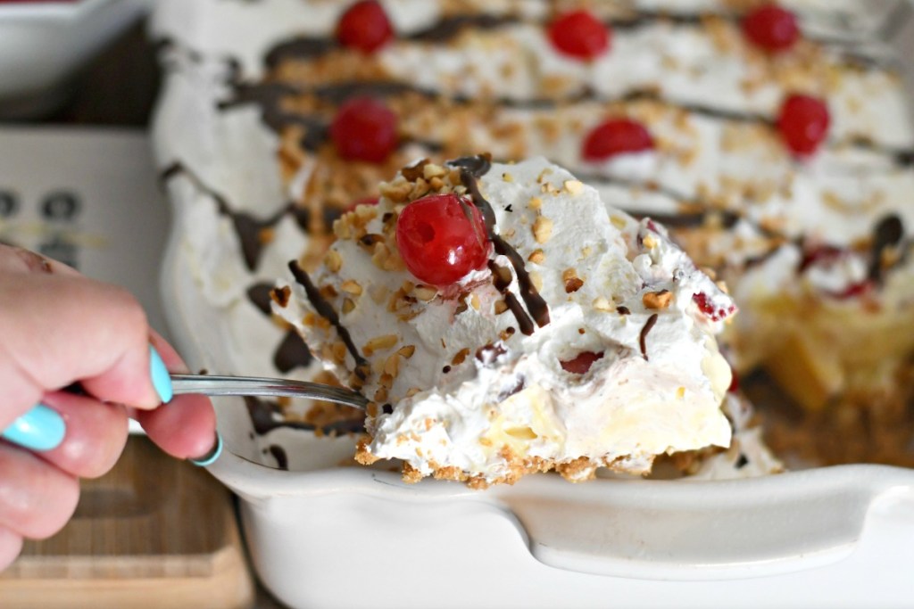 dishing up a slice of banana split dessert