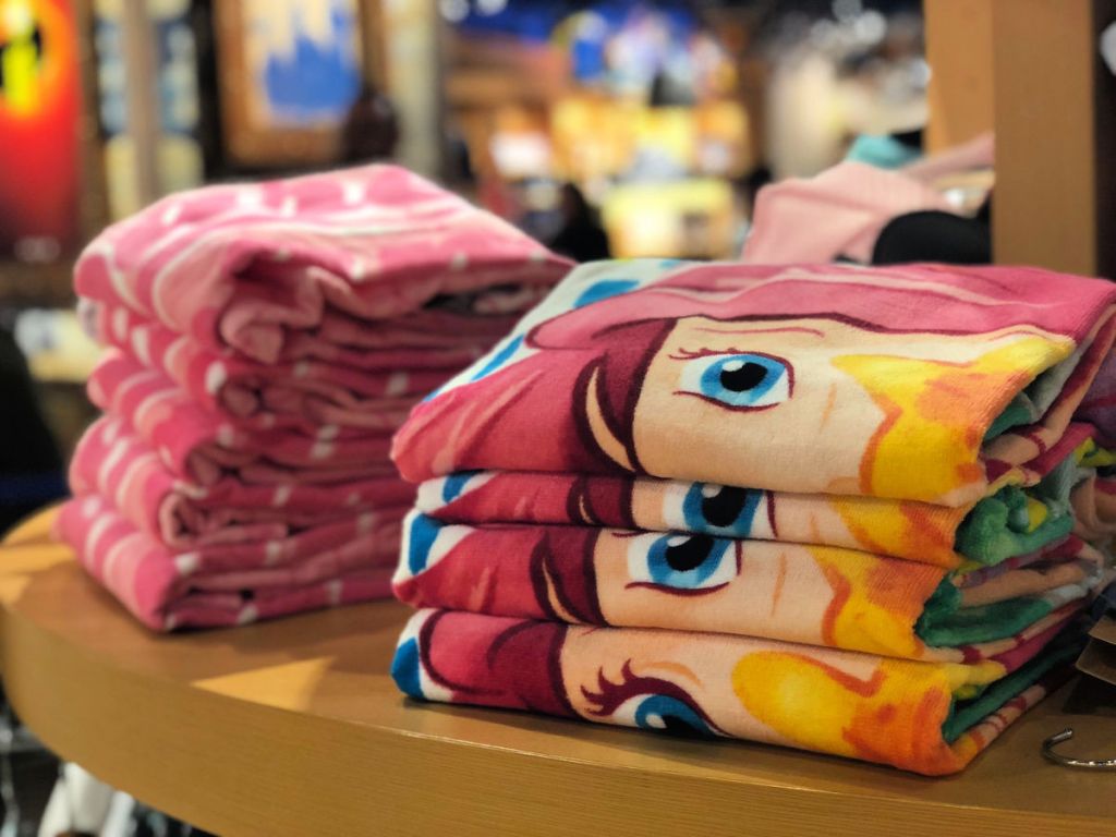 ariel disney beach towel folded on shelf