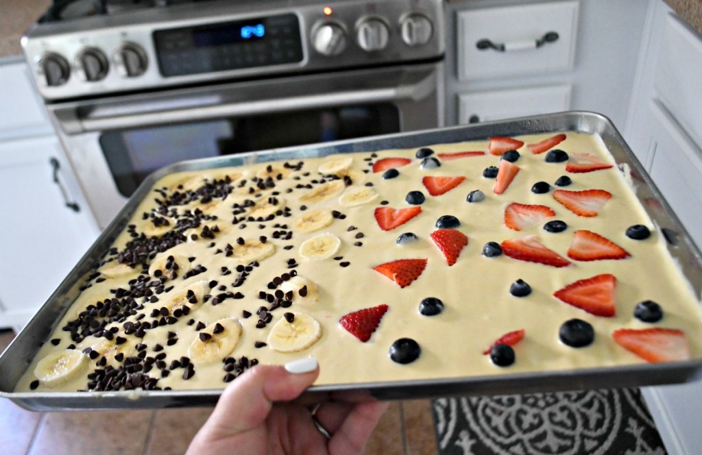 holding sheet pan pancakes going into the oven