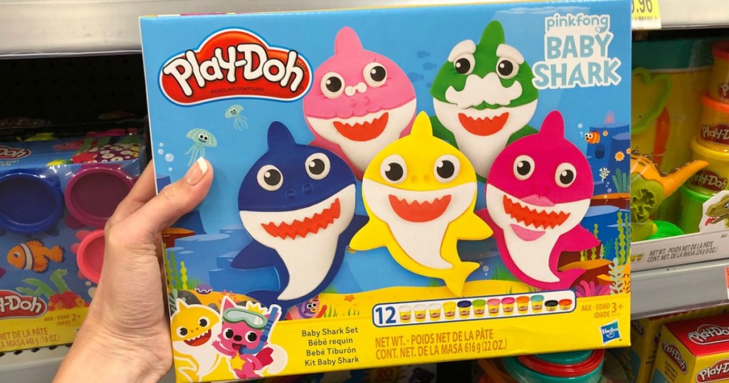 hand holding play doh set by store display