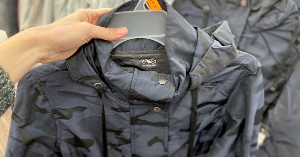 hand holding a Walmart fashion camo rain jacket