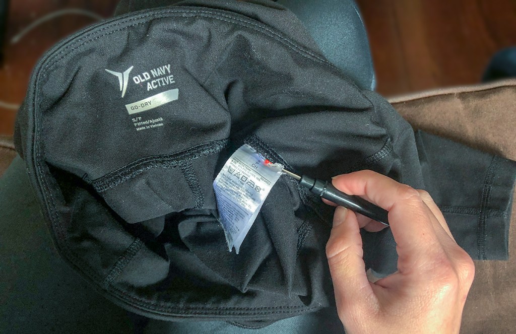 using a seam ripper to remove tags from apparel
