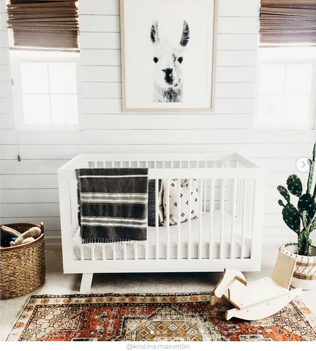 shiplap nursery wall with crib