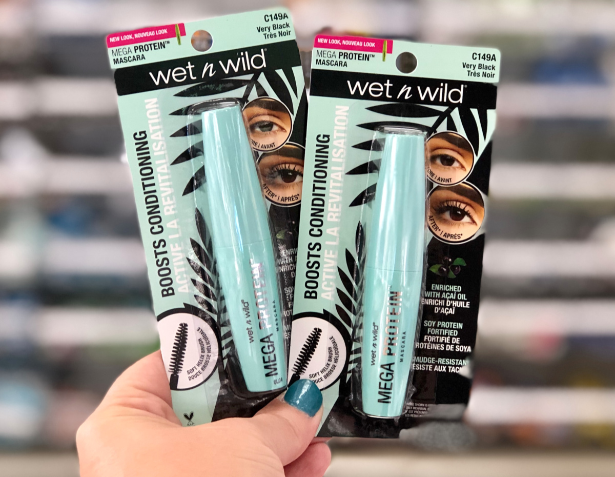 woman holding wet n wild mascaras