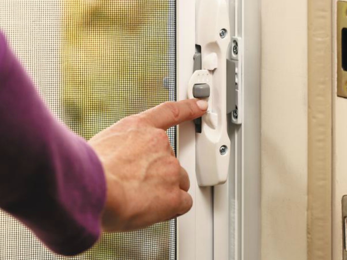 lady touching a Screen door latch