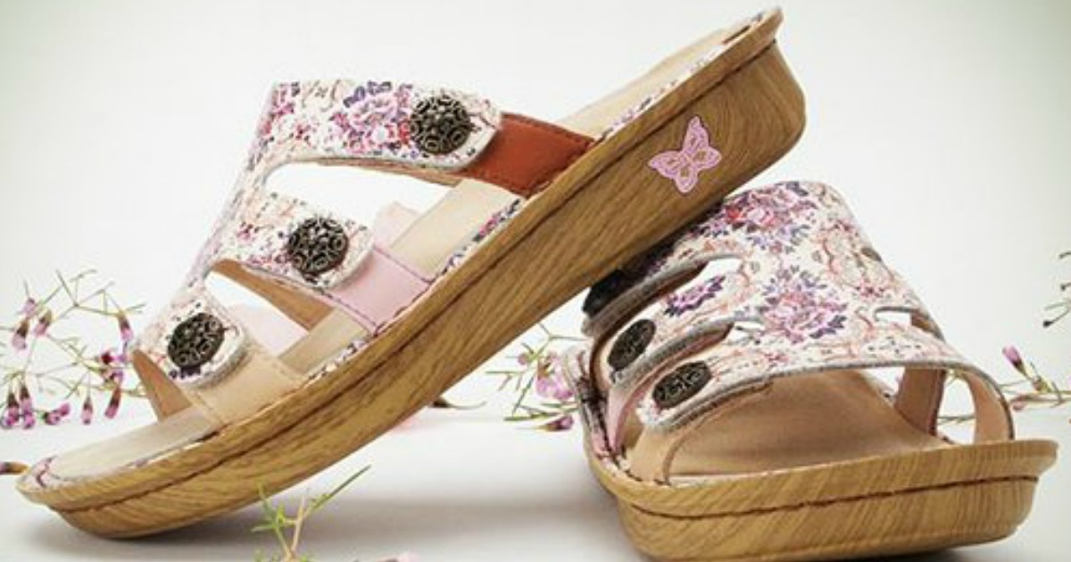 womens printed sandals displayed with flowers in background