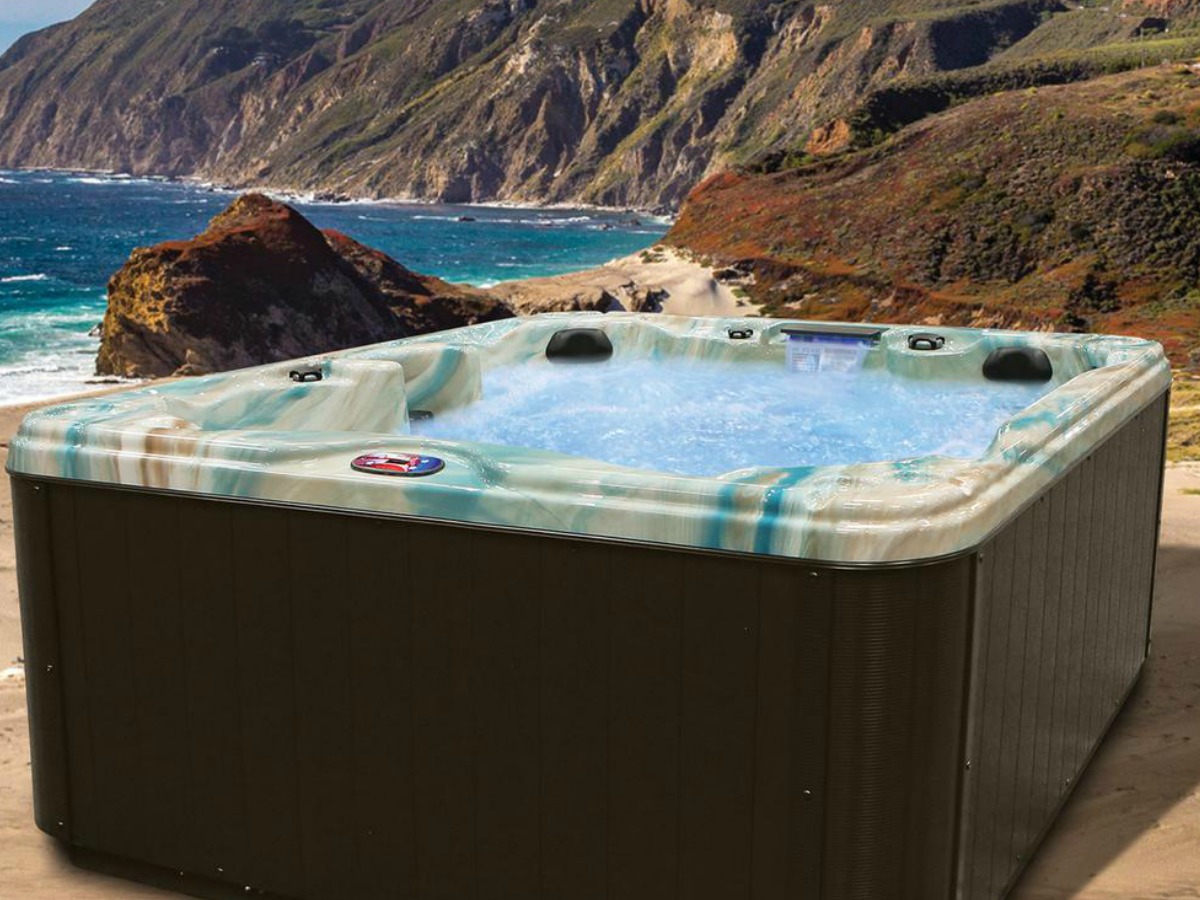 filled hot tub with blue detail by the ocean