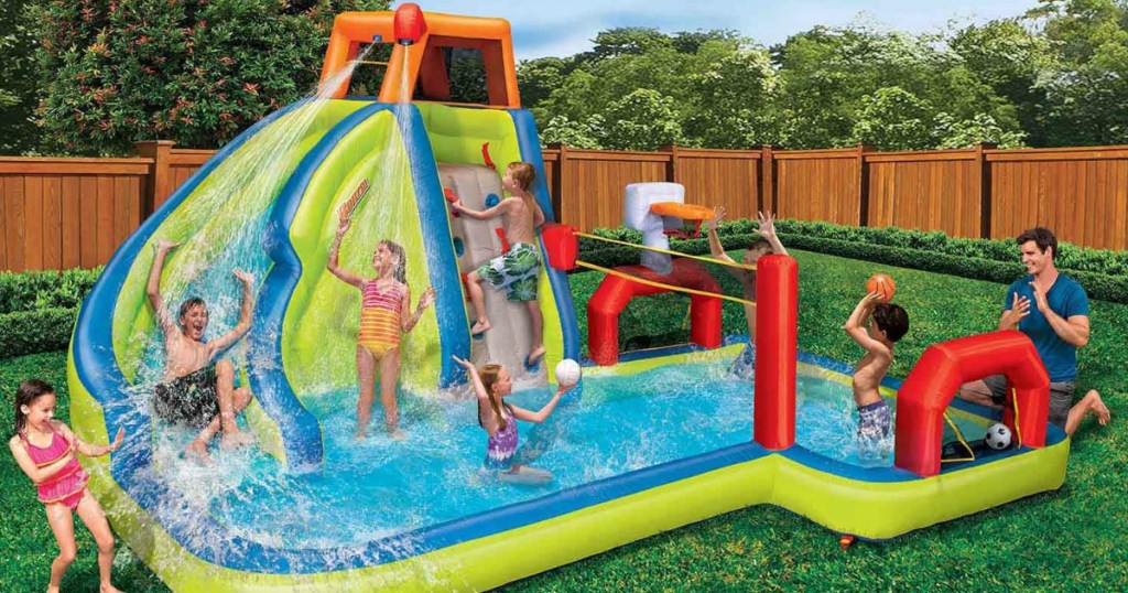 Kids and dad playing on Banzai Aqua Sports Water Park in backyard