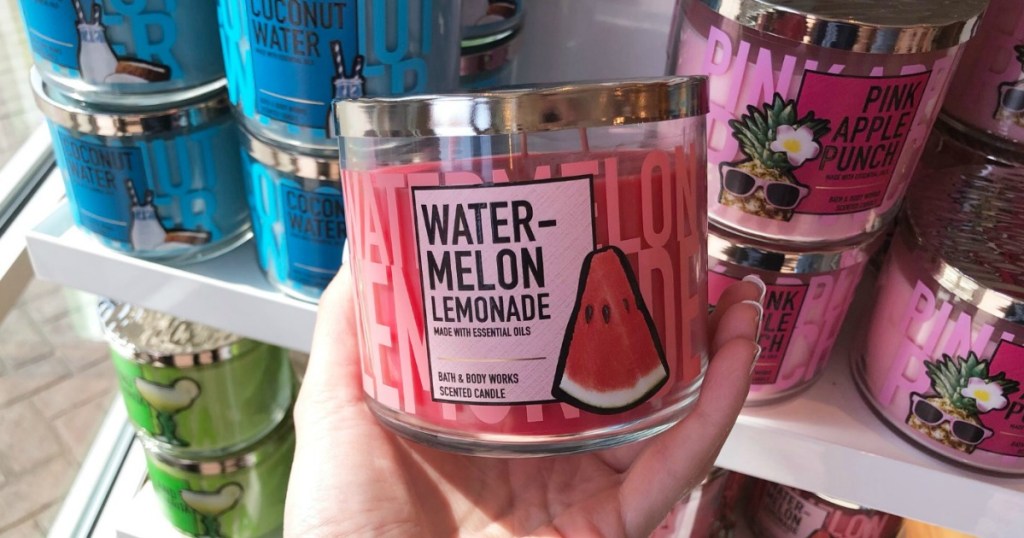 Woman holding Bath & Body Works Watermelon Lemonade 3-wick candle