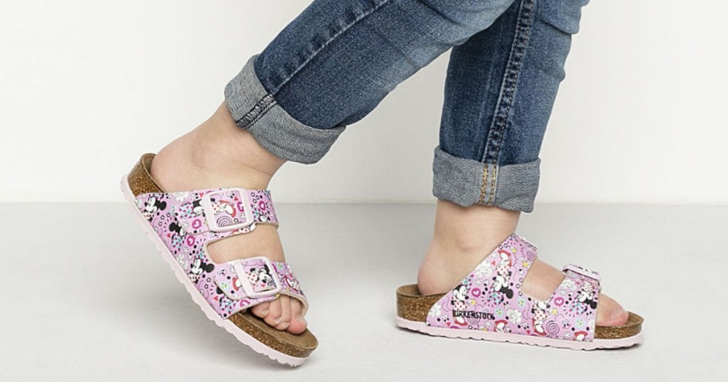 Girl wearing Birkenstock Kids Arizona Sandals in Disney Minnie Mouse print