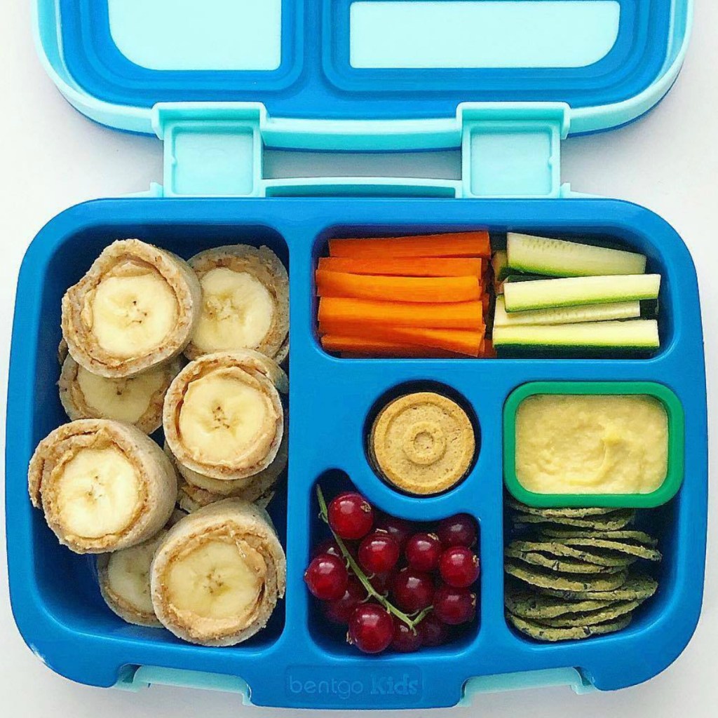 Blue bento kids lunch with veggies, fruit, hummus, and banana roll-ups