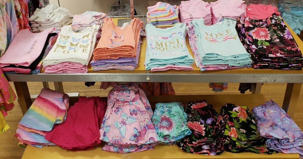 girl's tanks and skirts laying on a table