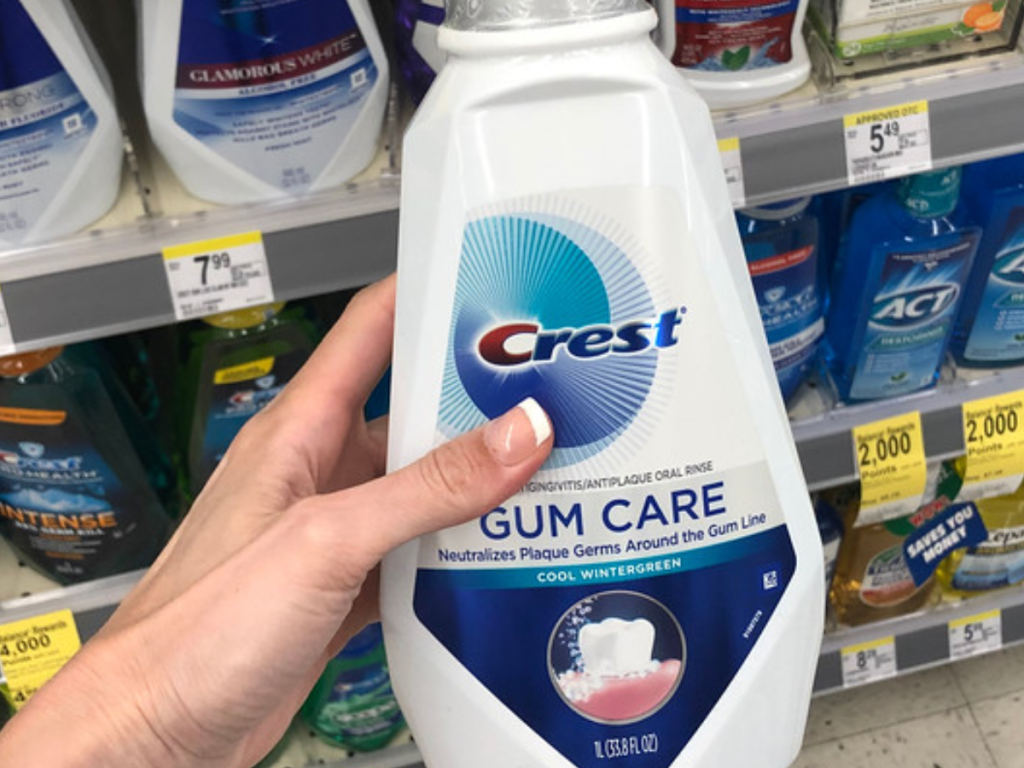 Woman's hand holding Crest Gum Care Mouthwash at Walgreens