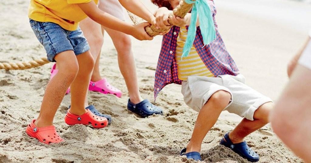 Family at the beach all wearing crocs