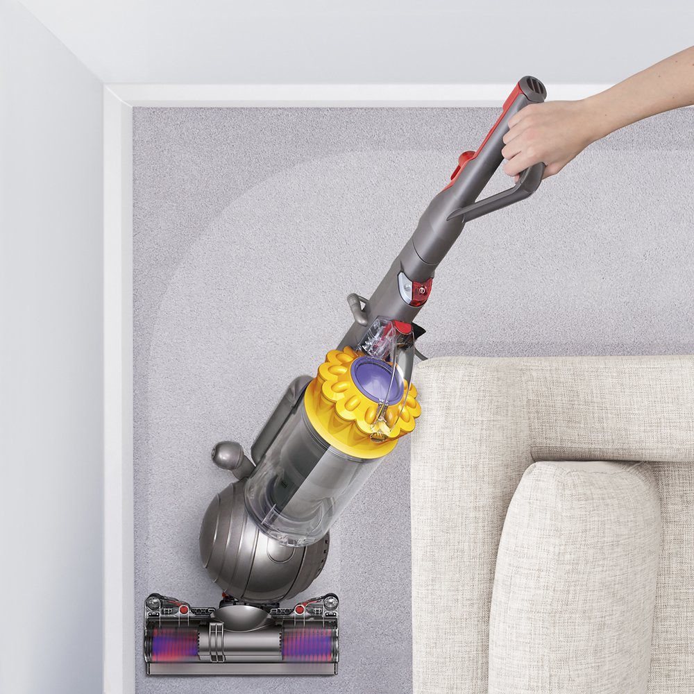 Dyson vacuum behind couch