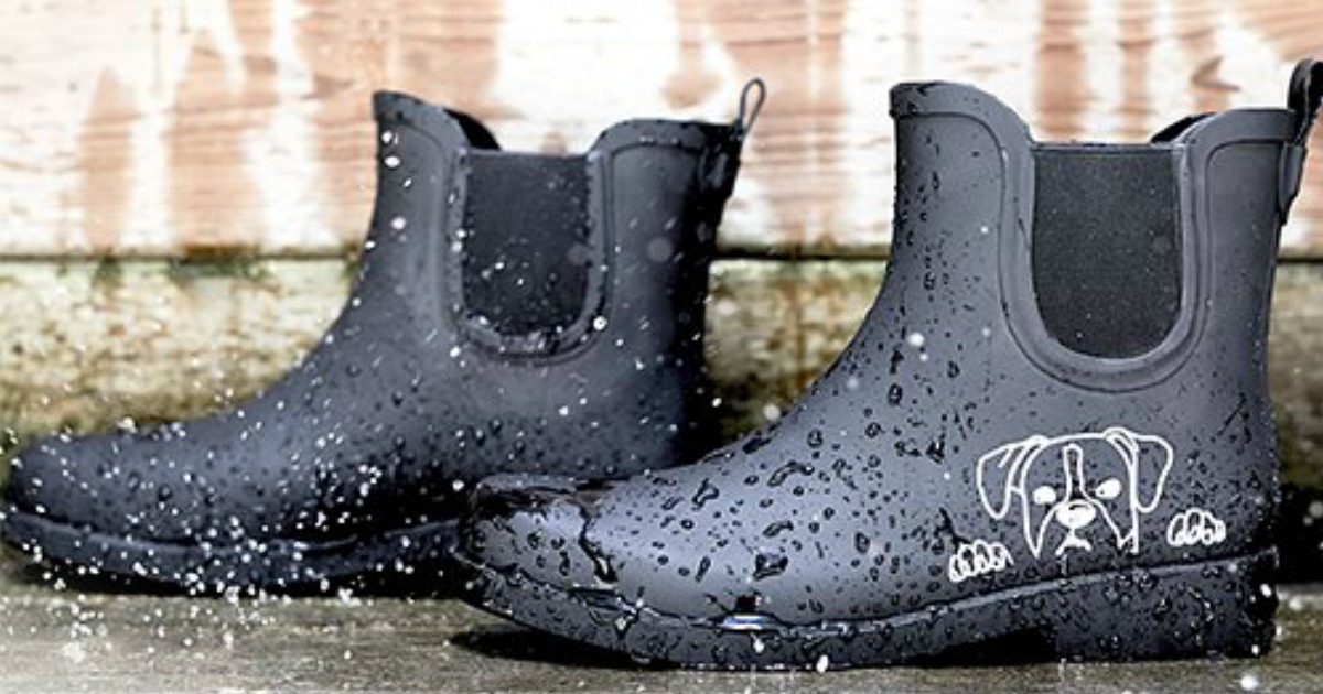 black rubber boots with dog stencil on the street in rain