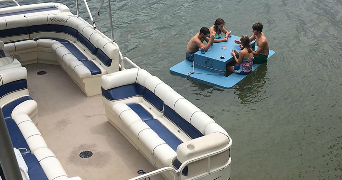 4 kids playing cards on floating picnic table