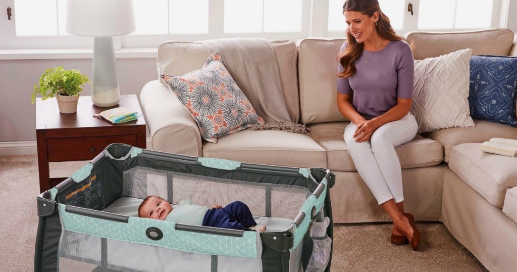 Mom on couch watching baby in playpen