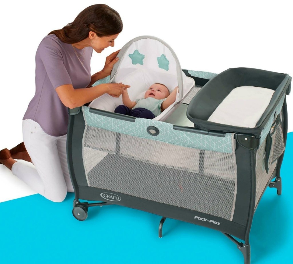 Mom with infant in graco pack n play