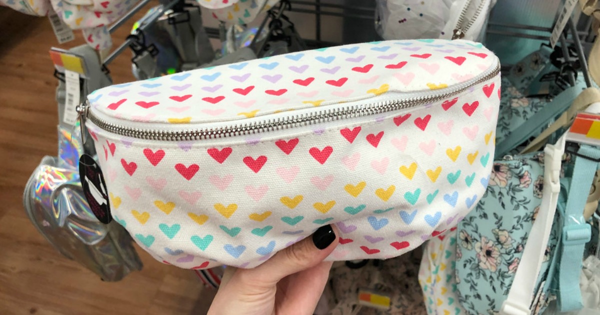 woman holding a Heart Fanny Pack at Walmart 