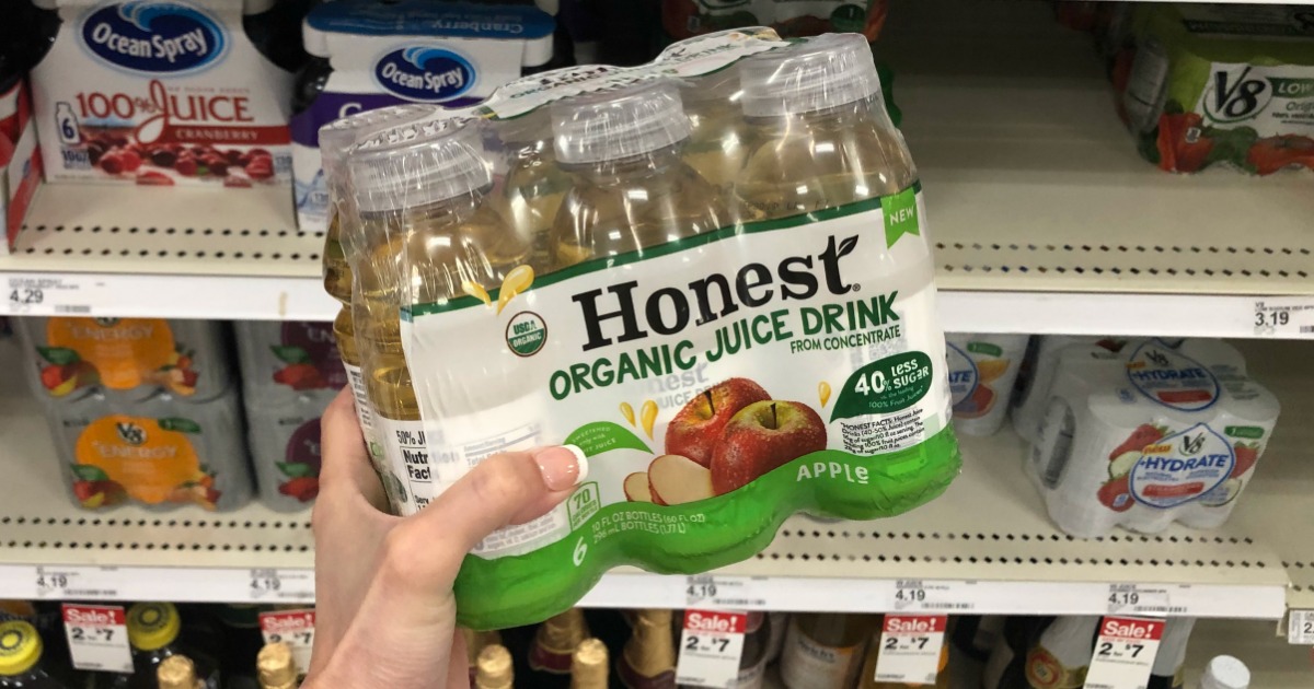 hand holding a 6-pack of Honest Organic Juice Drink in front of a store shelf