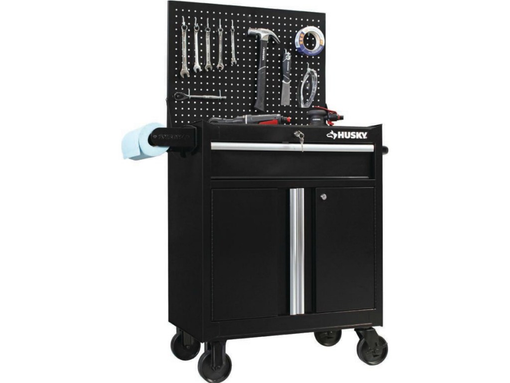 black rolling cabinet with tools hanging on attached pegboard