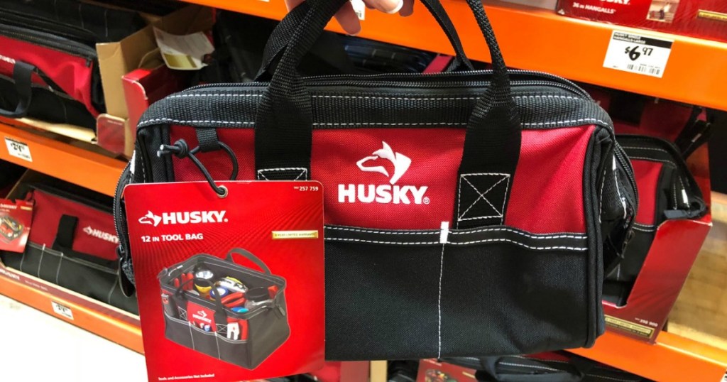 lady holding a 3-Bag onlinebo of a 15" Tool Tote, 12" Tool Bag, and 20" Duffle bags at home depot