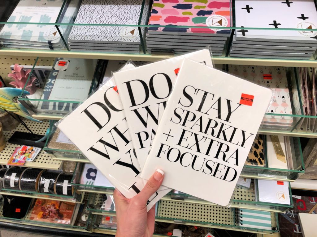 Woman holding Three Inspirational Quotes on Card stock in Hobby Lobby