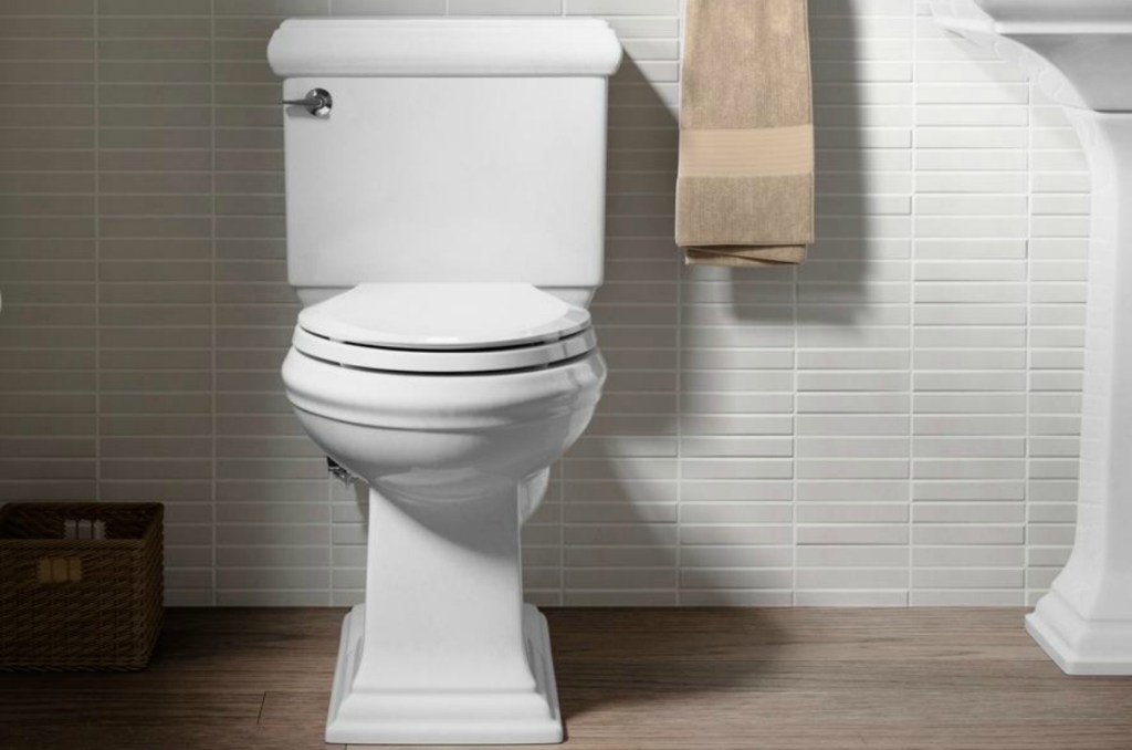 white toilet in tiled bathroom