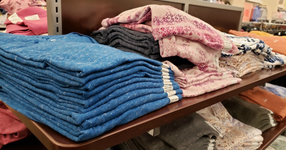 display shelf at Kohl's with women's basic tees folded on it