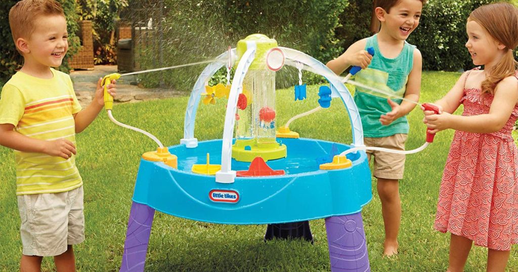 three kids playing in yard with little tikes fun zone battle splash water play table