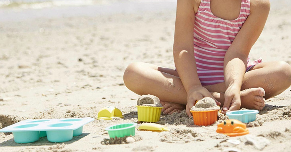 little girl playing with Melissa & Doug toys in the sand