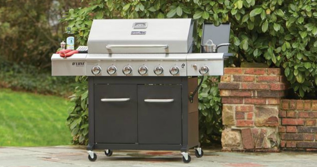 large silver and black Nexgrill 6-burner grill sitting in picturesque back yard