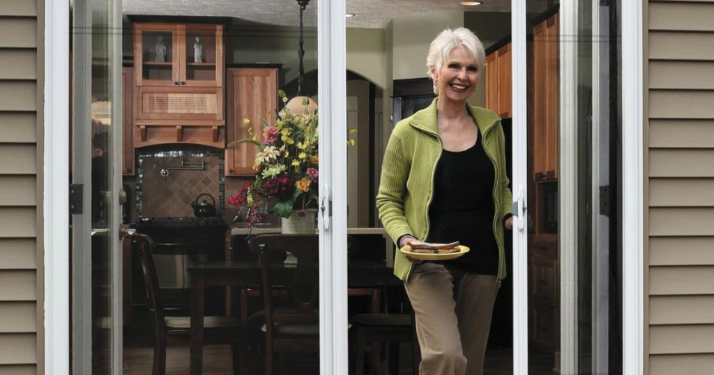 Woman opening screen door