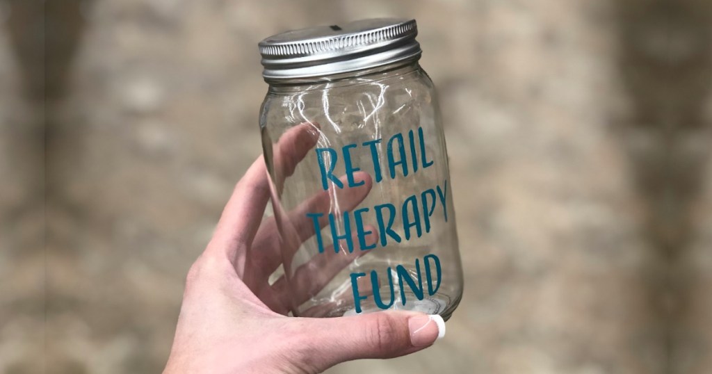 Woman holding Retail Therapy Fund Mason Jar