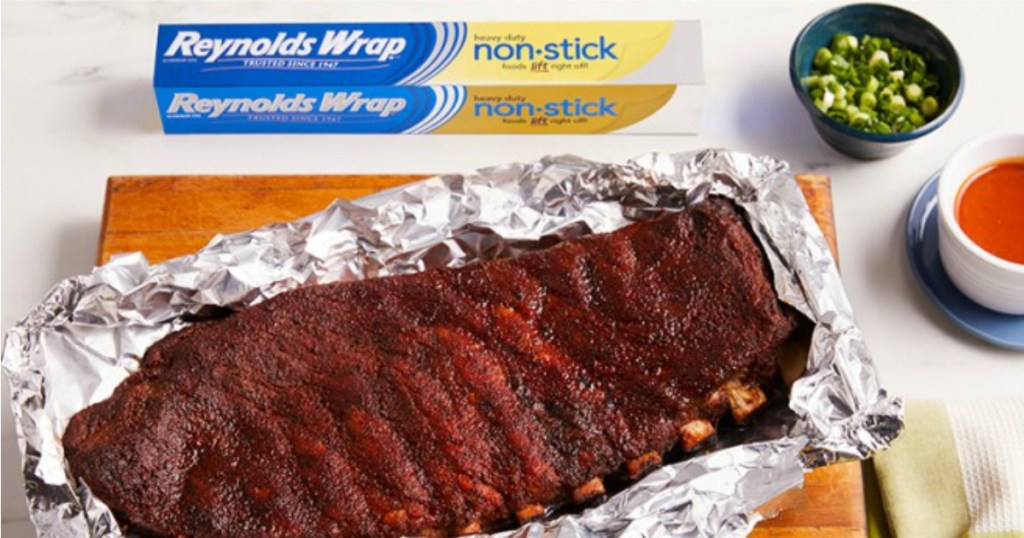 rack of ribs laid out on foil with box of foil next to it