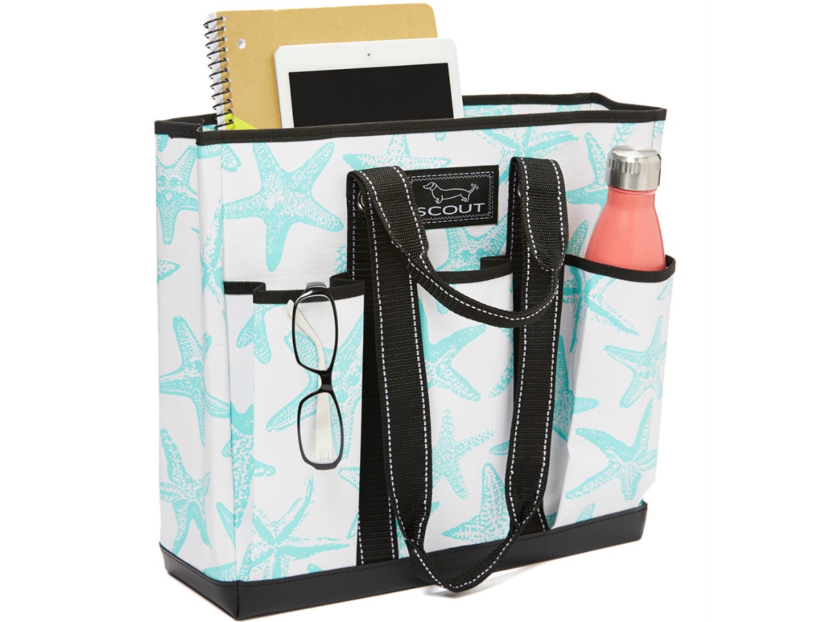 teal and white tote with three front pockets filled with water bottle and other gadgets