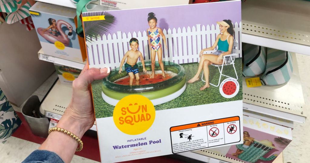 Woman holding sun squad inflatable watermelon pool in target