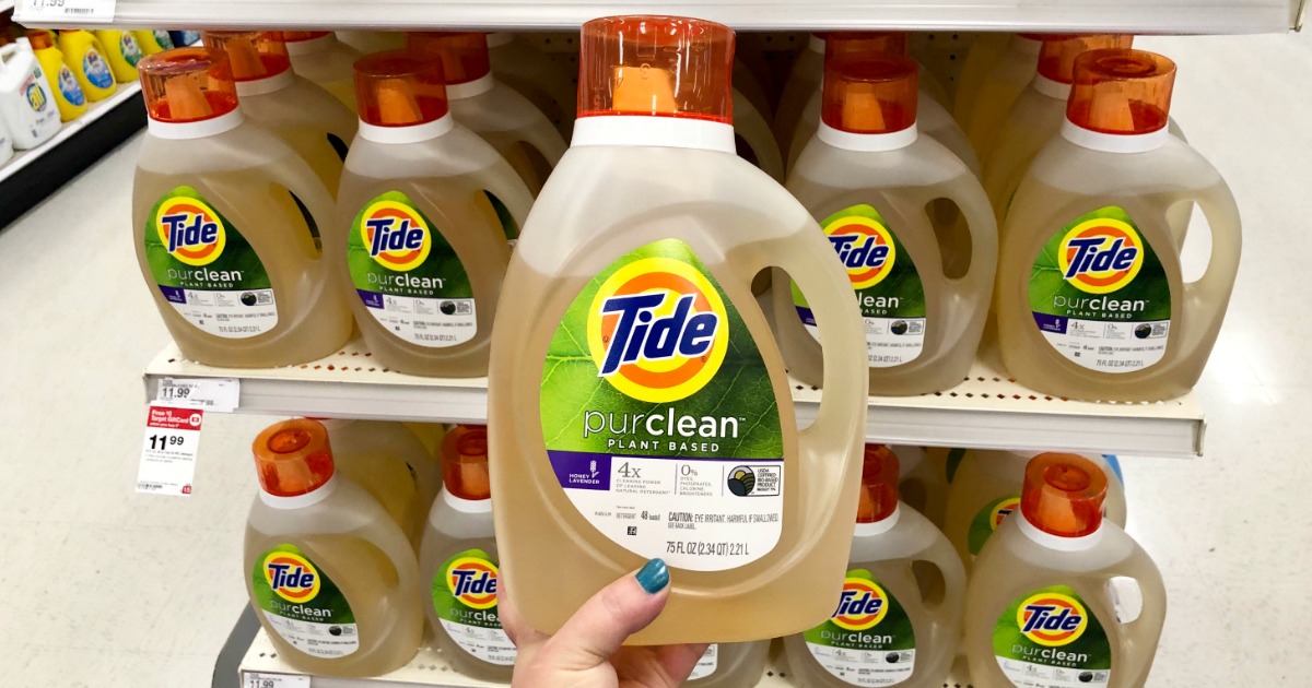 woman holding Tide PurClean detergent bottle in Target