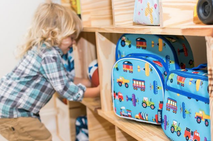 Boy playing next to Wildkin Olive Kids Trains, Planes & Trucks Lunch Box