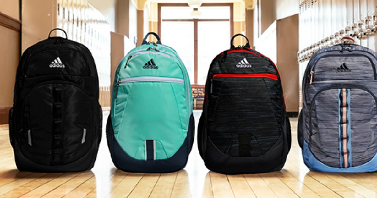 adidas backpacks lined up in a school hallway