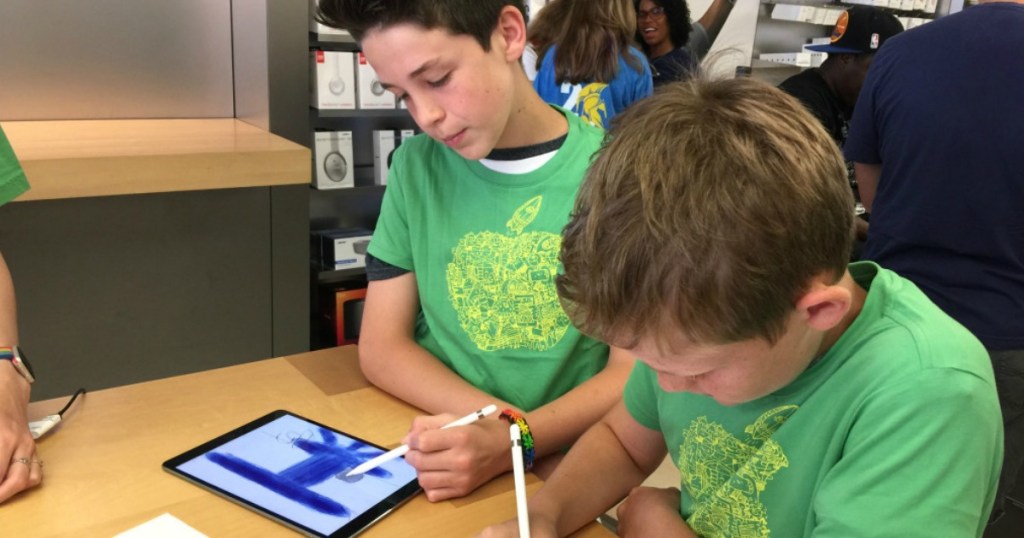 two boys in class working on iPads