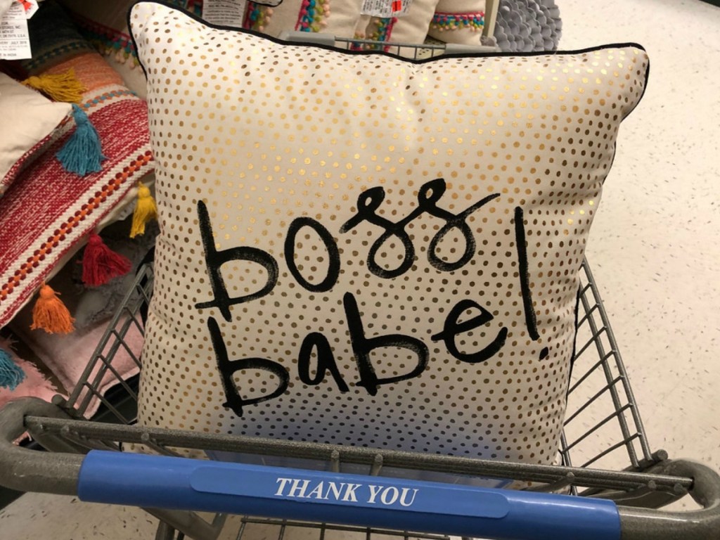 gold and black pillow in shopping cart